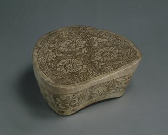 Pillow Transparent glaze with arabesque on dotted ground incised through the white slip to the body
